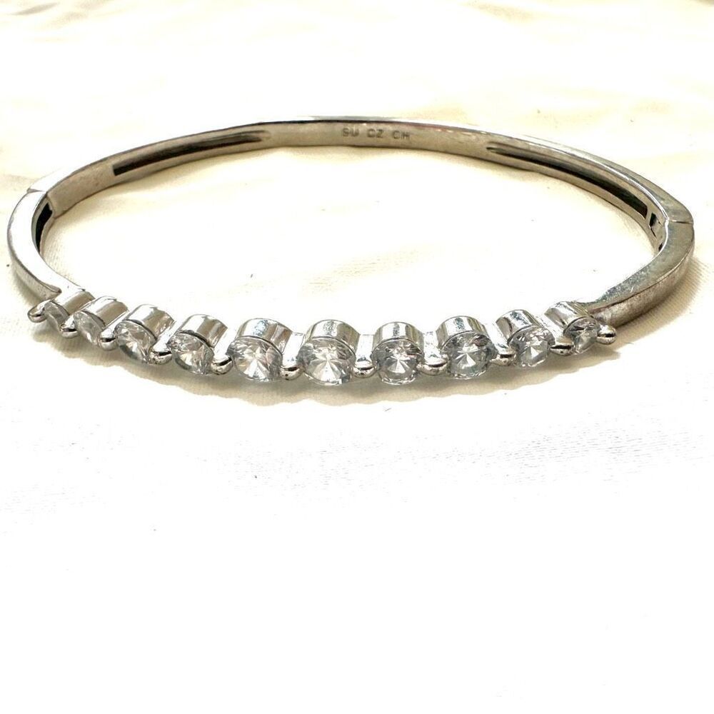 Rhodium plated cubic zirconia hinged bangle bracelet